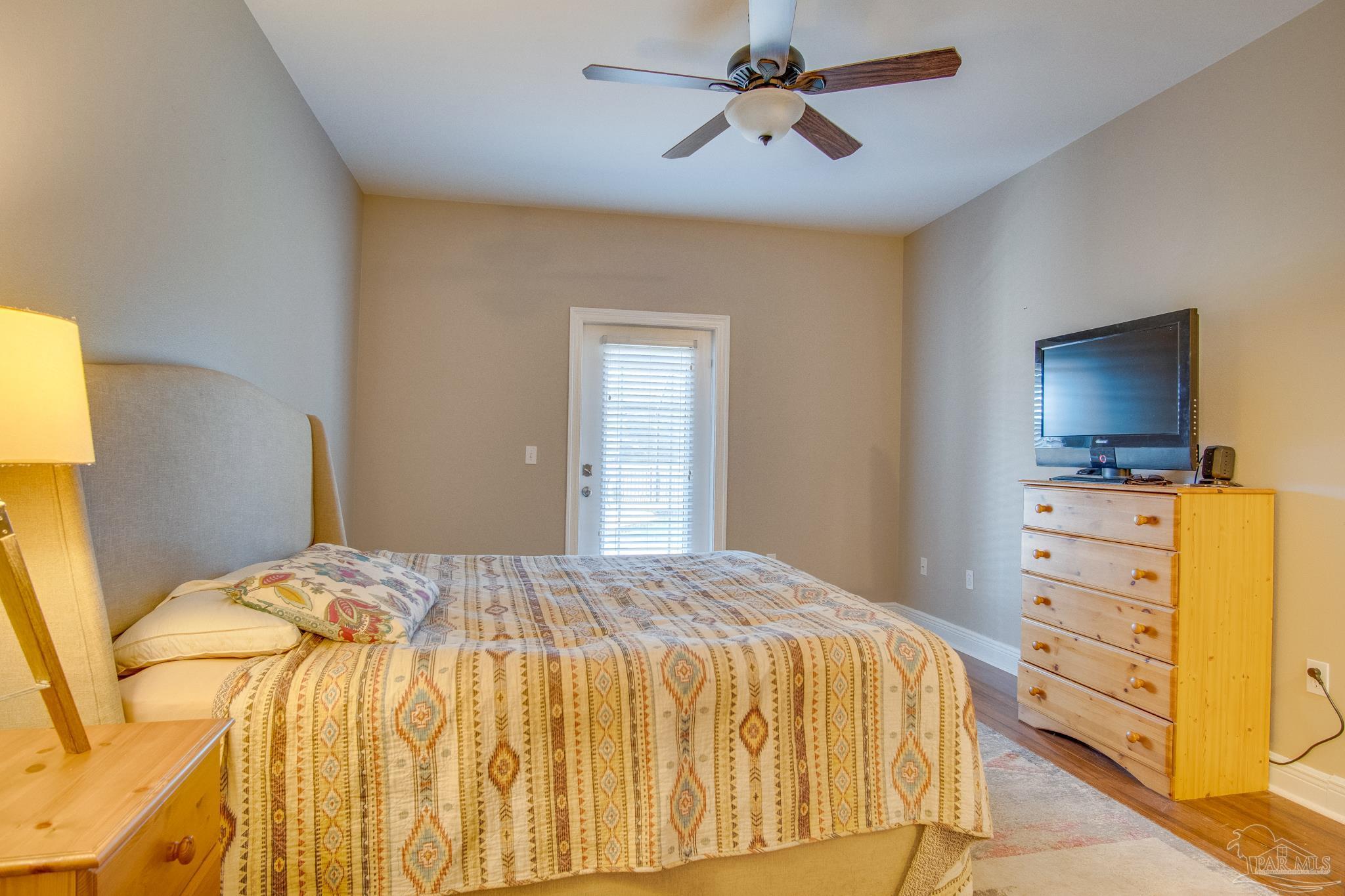2655 Masters Boulevard Navarre, FL 32566 - Photo 31 of 43 a bedroom with a bed and wooden floor