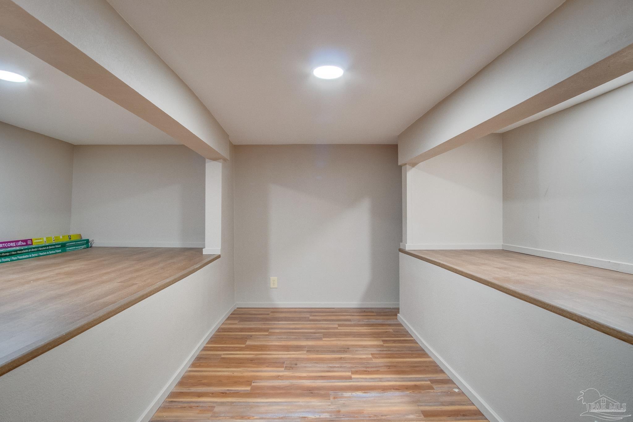 2655 Masters Boulevard Navarre, FL 32566 - Photo 33 of 43 a hallway view with wooden floor