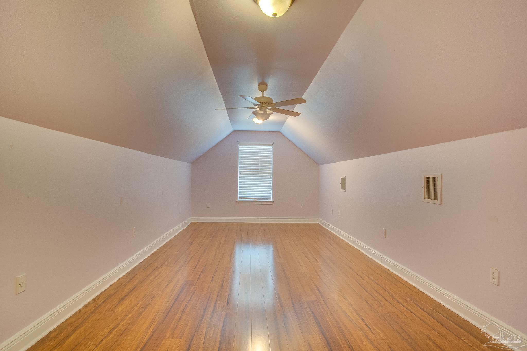 2655 Masters Boulevard Navarre, FL 32566 - Photo 34 of 43 wooden floor in an empty room with a window