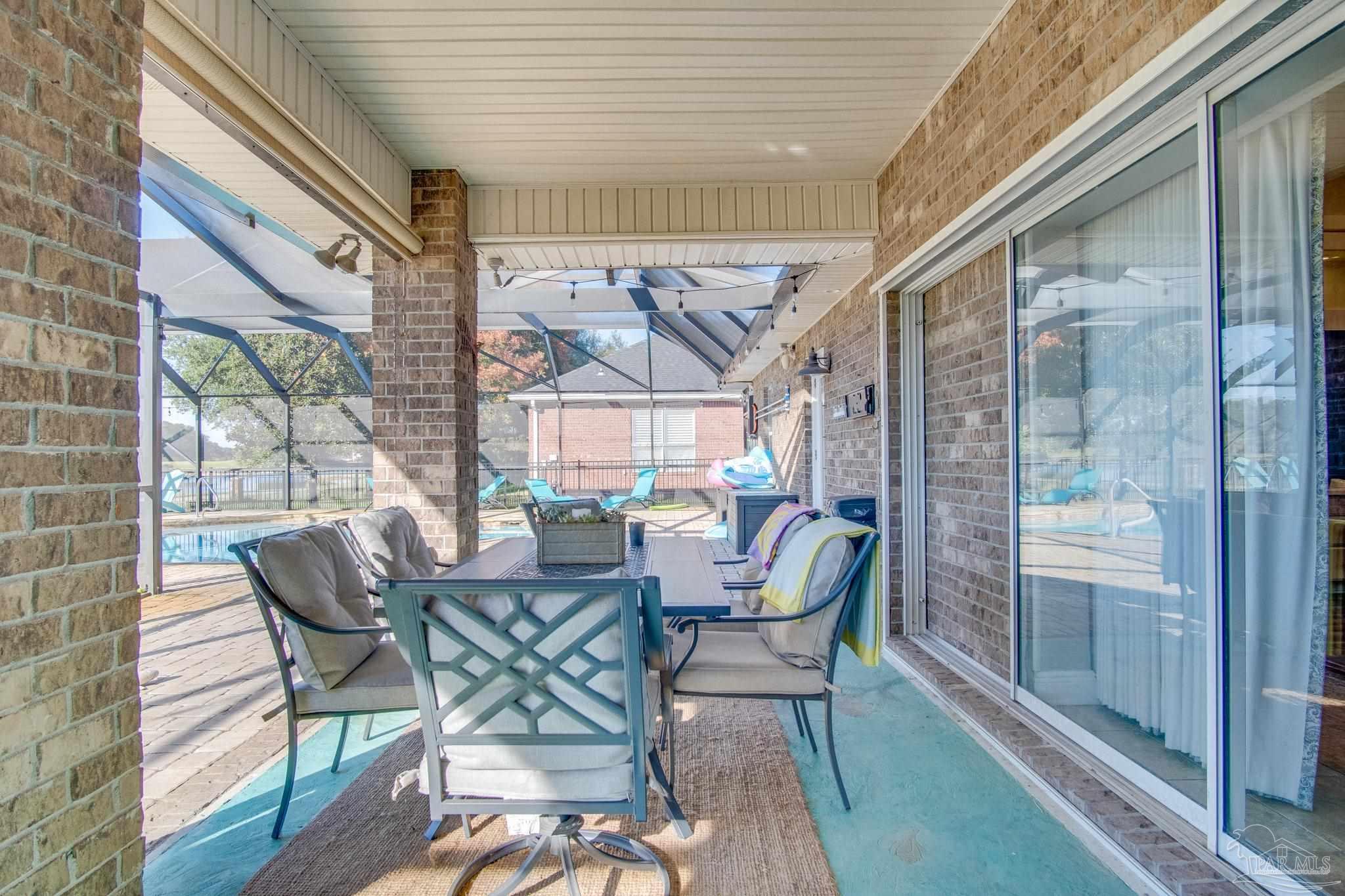 2655 Masters Boulevard Navarre, FL 32566 - Photo 39 of 43 a view of a porch with chairs and backyard