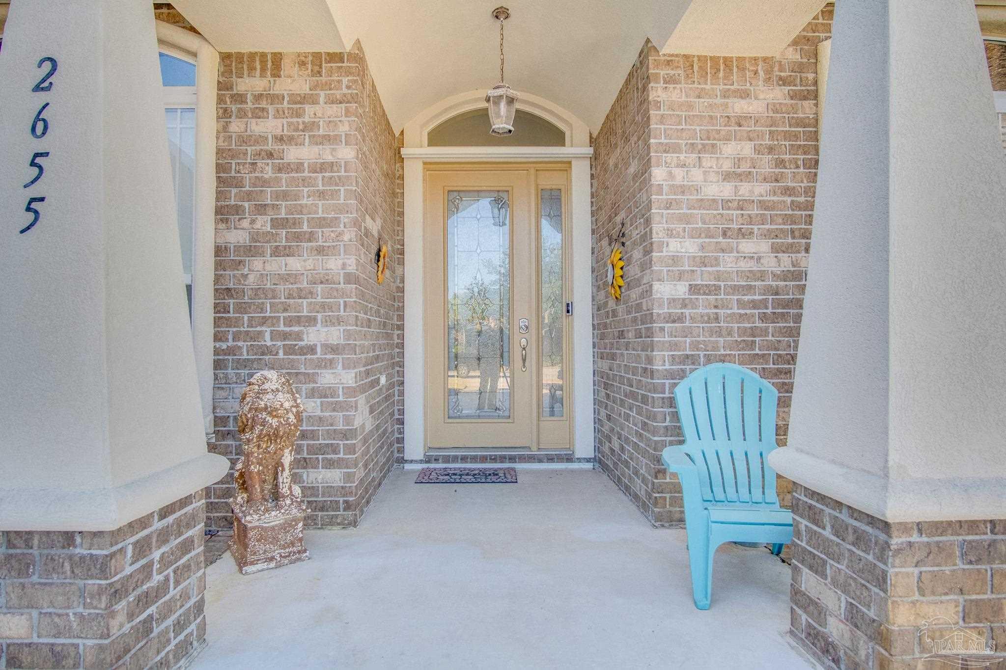 2655 Masters Boulevard Navarre, FL 32566 - Photo 4 of 43 a view of wooden door with chair and a door