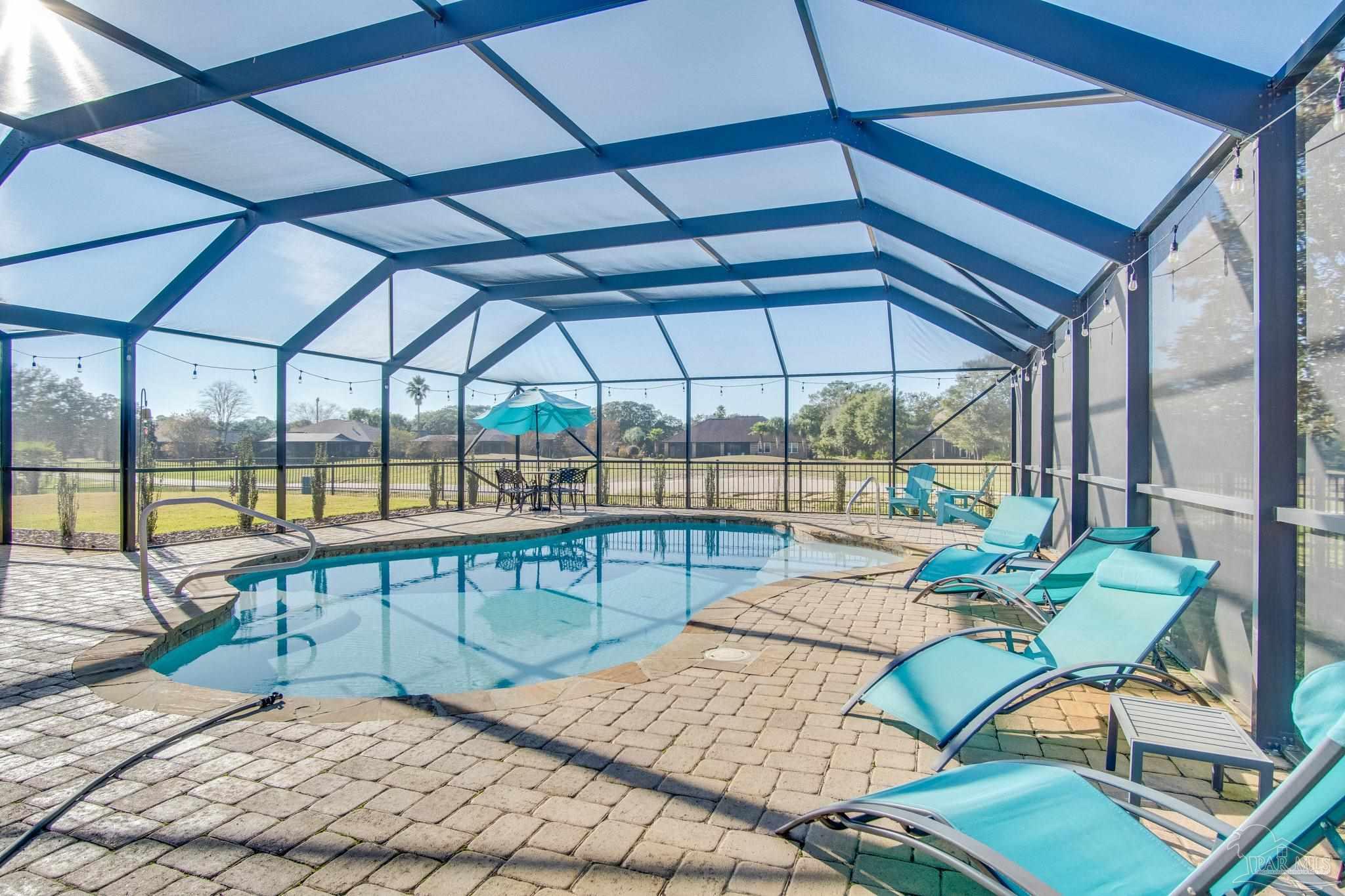 2655 Masters Boulevard Navarre, FL 32566 - Photo 41 of 43 a view of a swimming pool with a patio