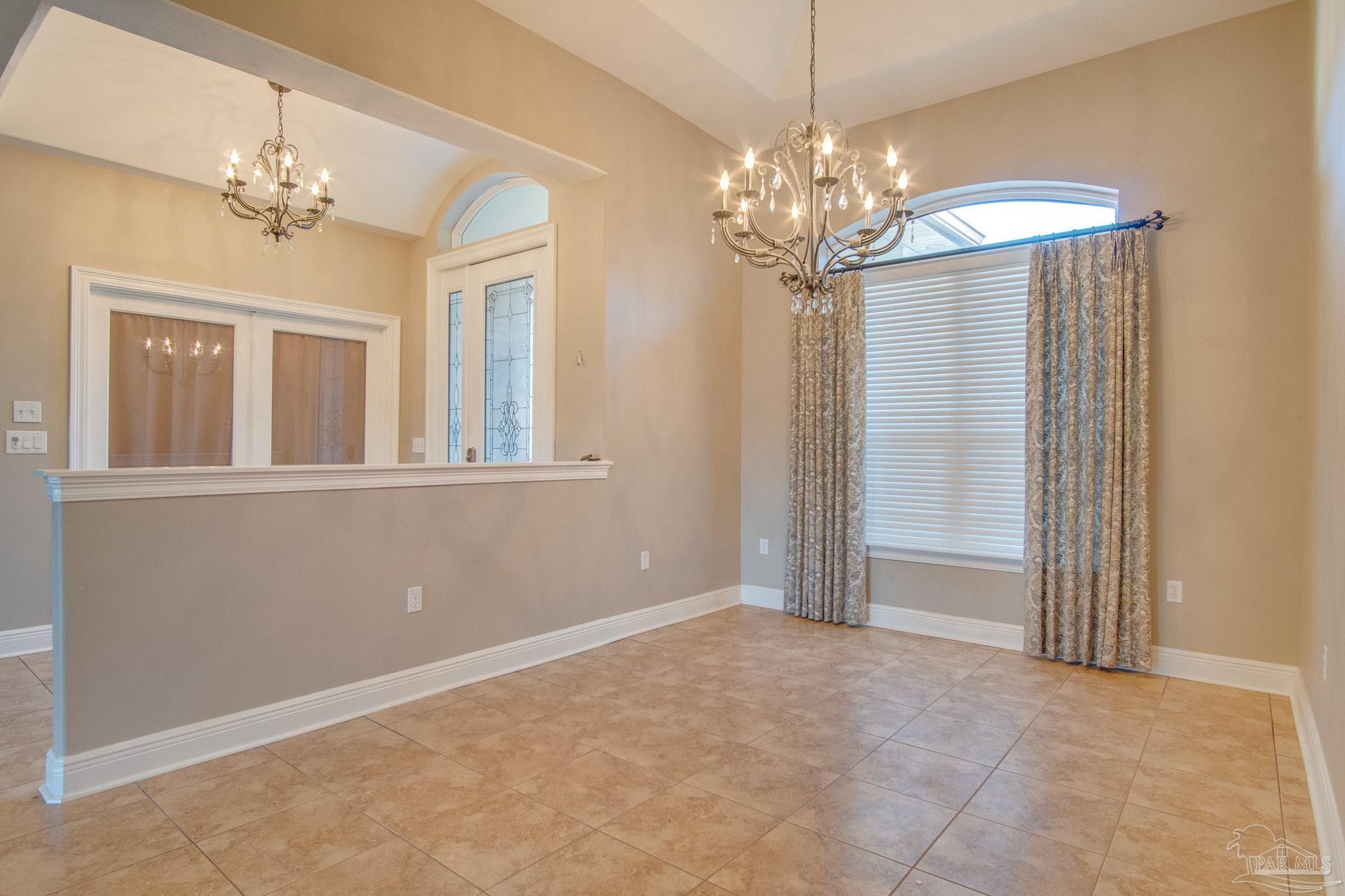 2655 Masters Boulevard Navarre, FL 32566 - Photo 6 of 43 a view of a chandelier in a room with a chandelier