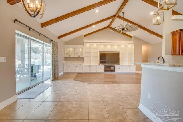 a view of a hallway with a chandelier and fireplace