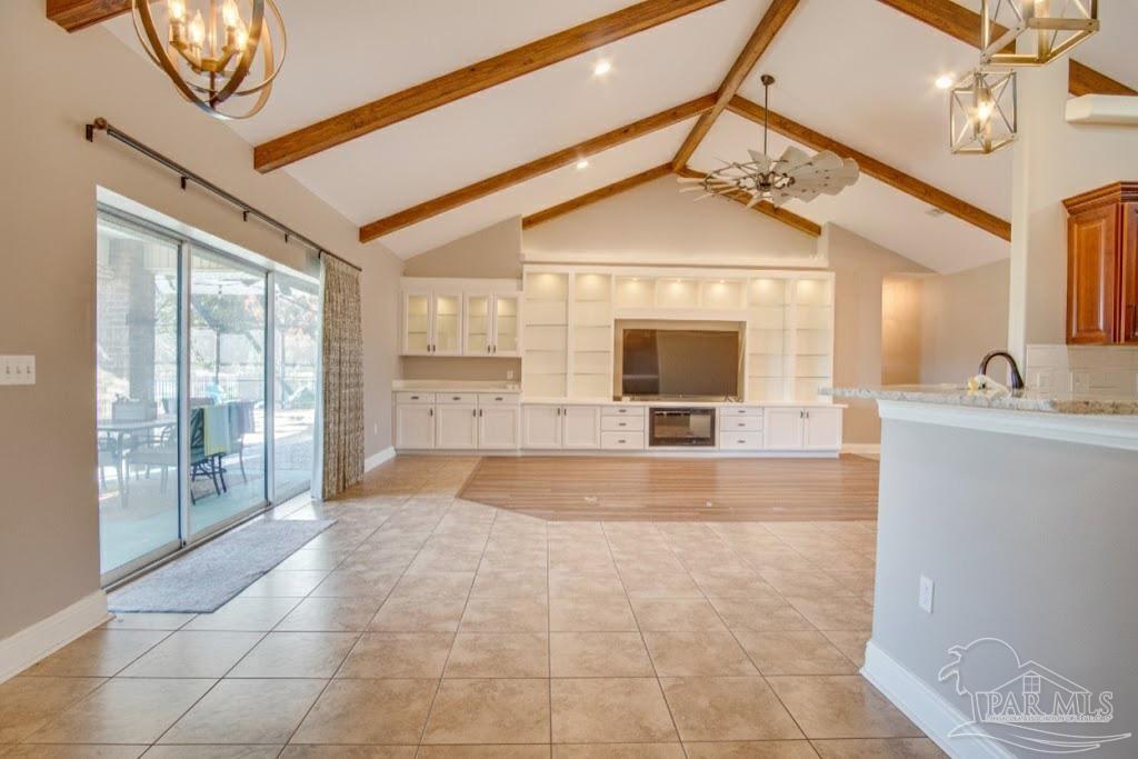 2655 Masters Boulevard Navarre, FL 32566 - Photo 7 of 43 a view of a hallway with a chandelier and fireplace