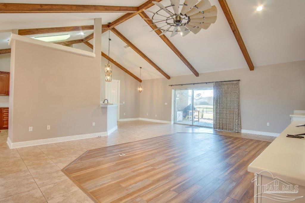 2655 Masters Boulevard Navarre, FL 32566 - Photo 8 of 43 a view of an empty room with wooden floor and windows