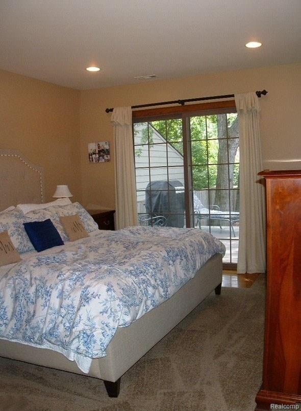 2478 Pembroke Road Birmingham, MI 48009 - Photo 19 of 38 1st floor master suite touts private doorwall to deck, elegant bath, huge walk-in closet with built-ins, neutral carpet & paint, & recessed lights