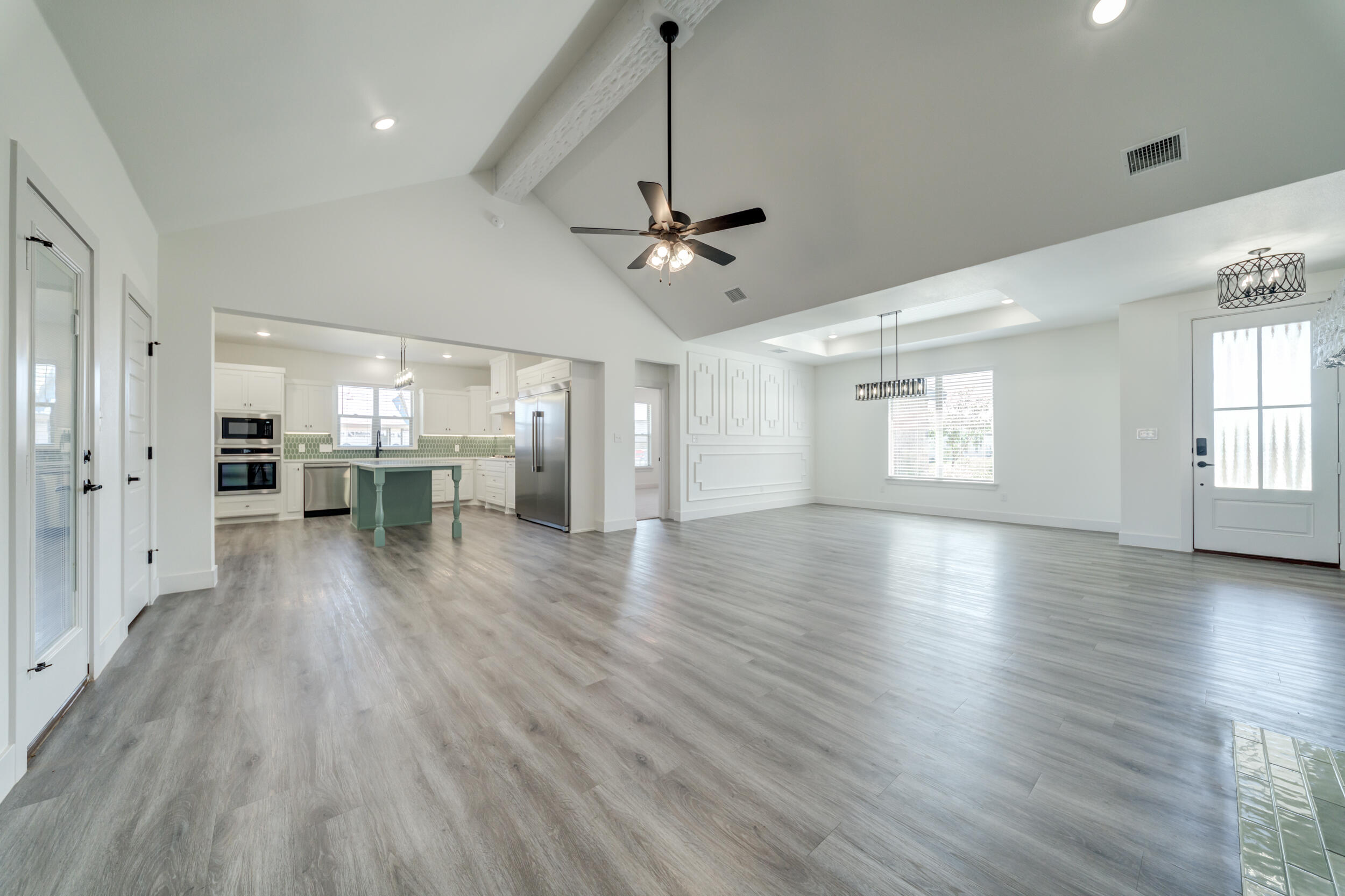 7522 56th Street Lubbock, TX 79407 - Photo 12 of 47 a view of an empty room with a window and wooden floor