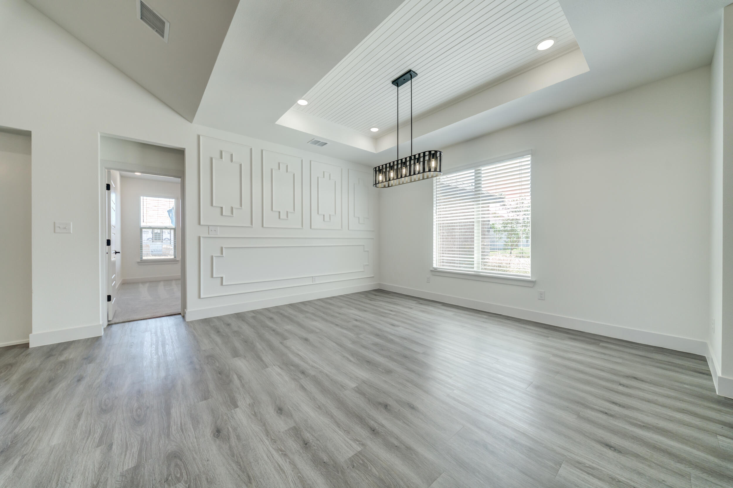 7522 56th Street Lubbock, TX 79407 - Photo 16 of 47 an empty room with wooden floor cabinet and windows