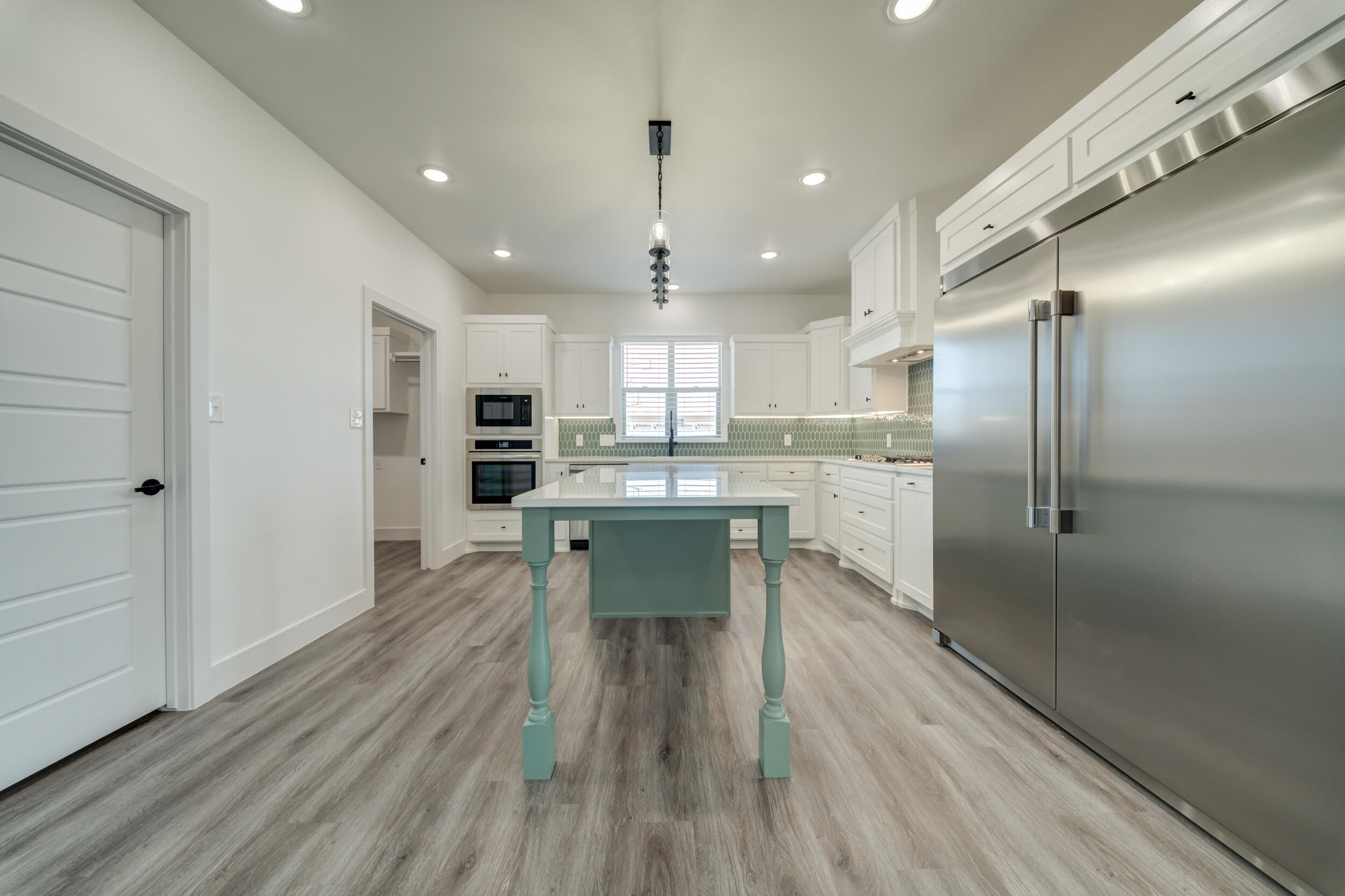 7522 56th Street Lubbock, TX 79407 - Photo 17 of 47 a kitchen with stainless steel appliances a refrigerator sink and cabinets
