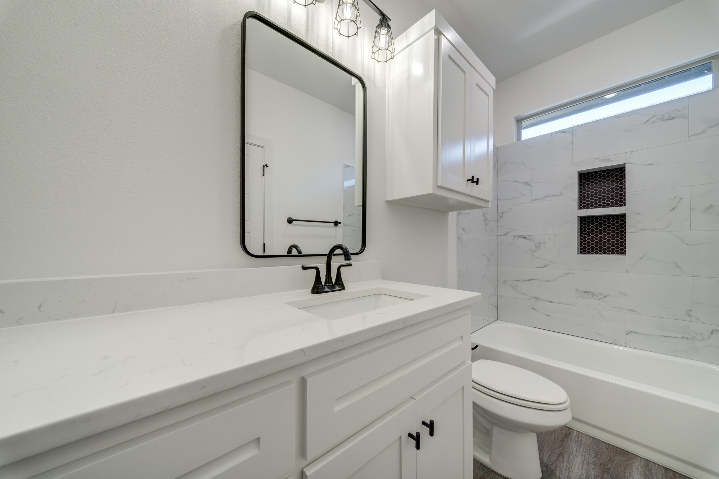 7522 56th Street Lubbock, TX 79407 - Photo 24 of 47 a bathroom with a sink a toilet and a bathtub