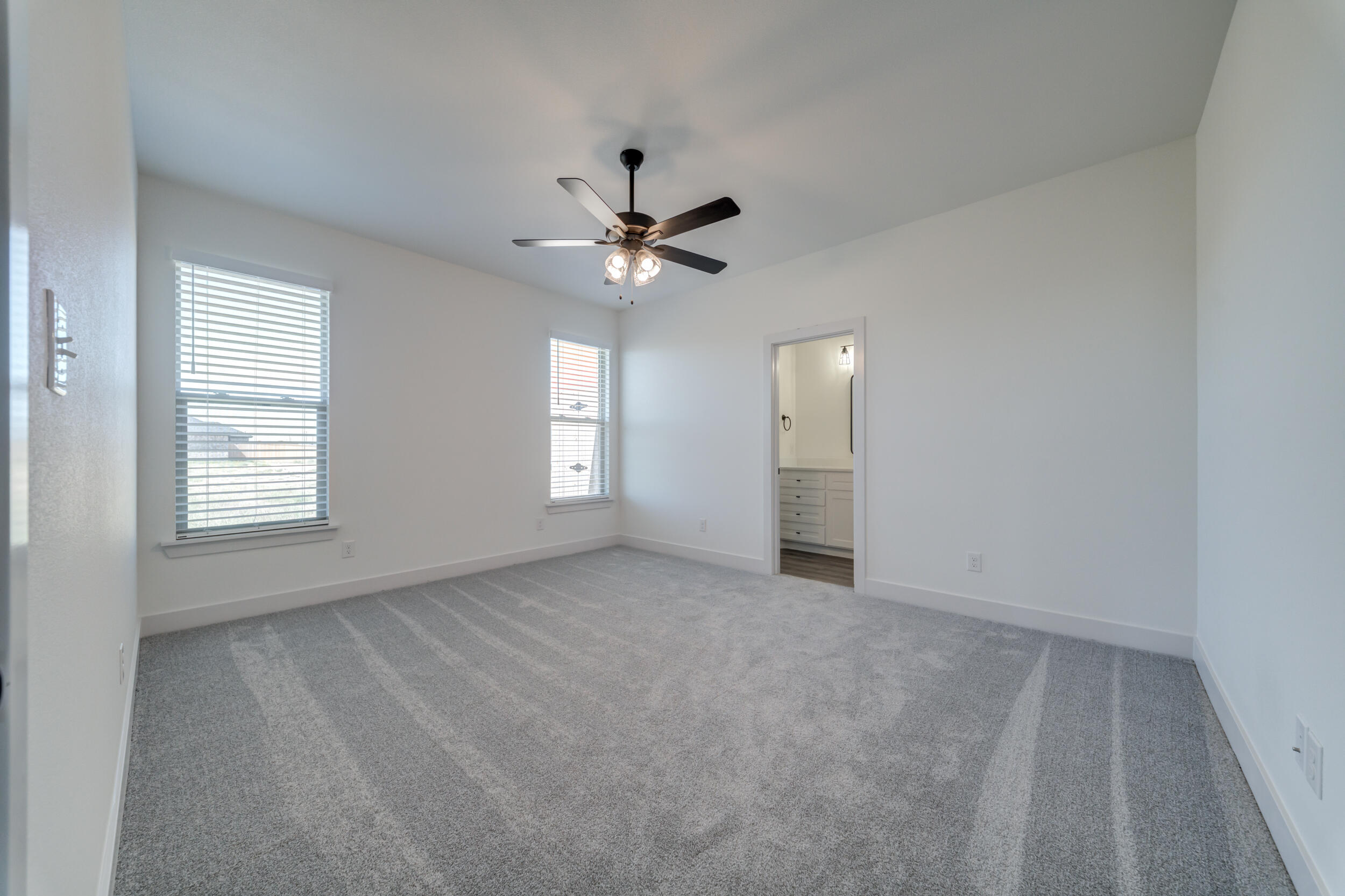 7522 56th Street Lubbock, TX 79407 - Photo 27 of 47 an empty room with windows and fan