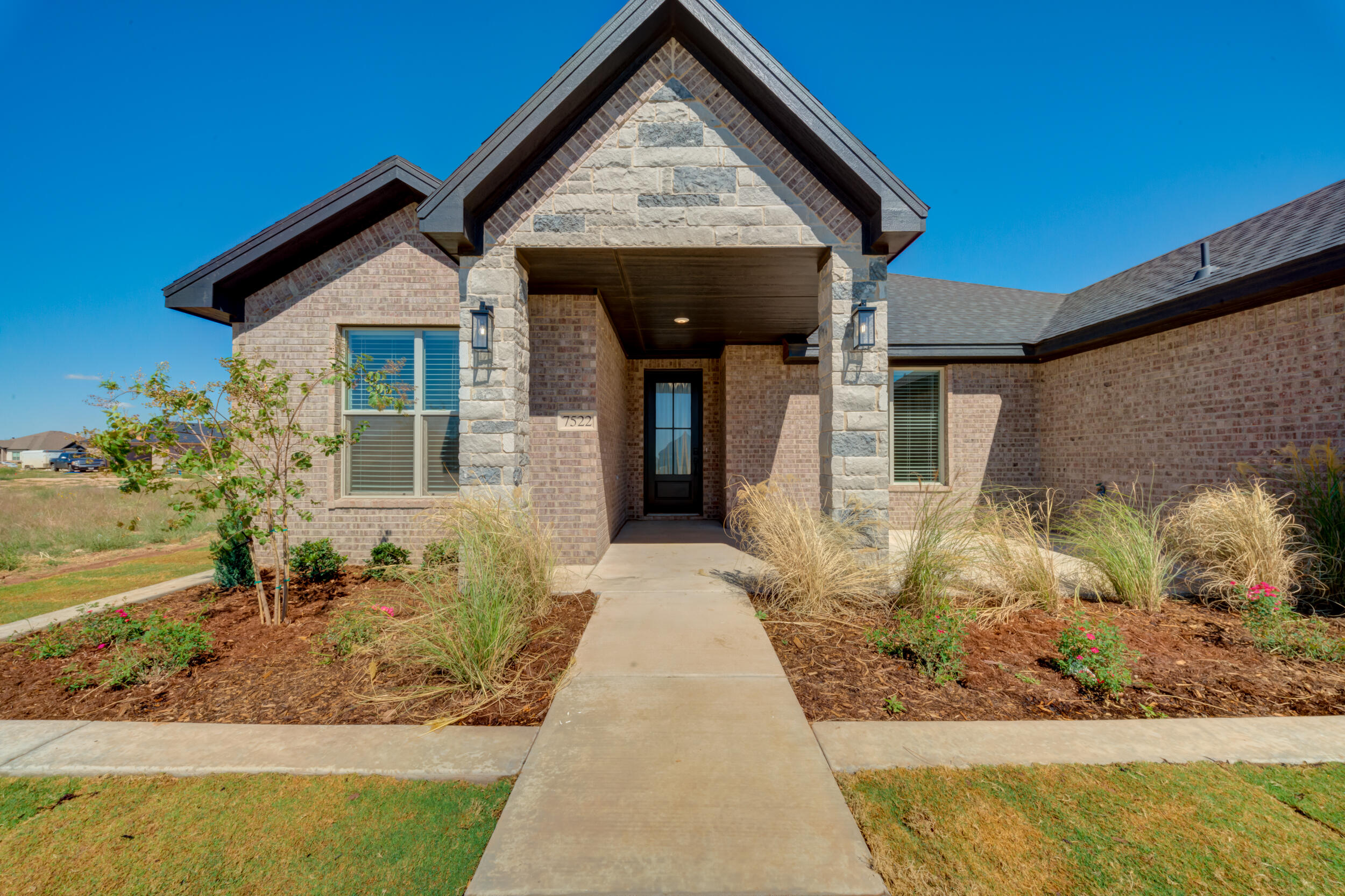 7522 56th Street Lubbock, TX 79407 - Photo 3 of 47 a front view of a house with garden