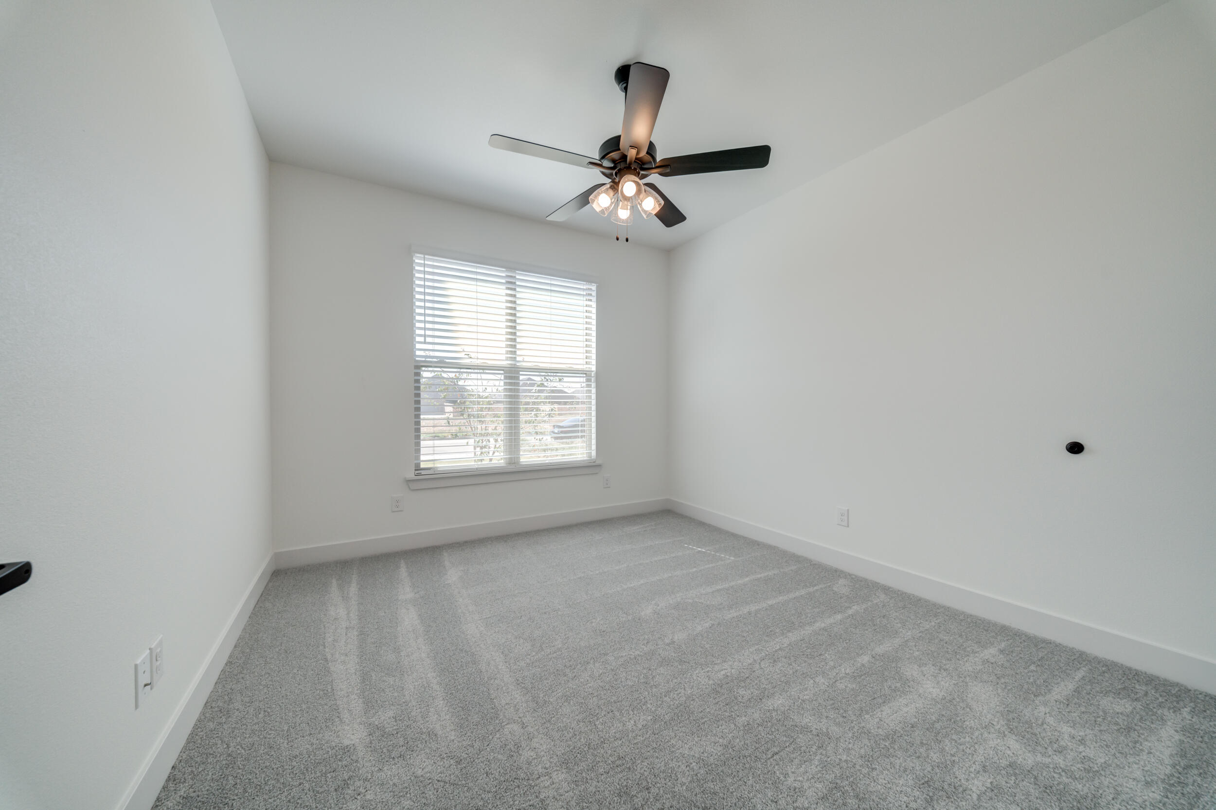 7522 56th Street Lubbock, TX 79407 - Photo 31 of 47 an empty room with a window and a fan