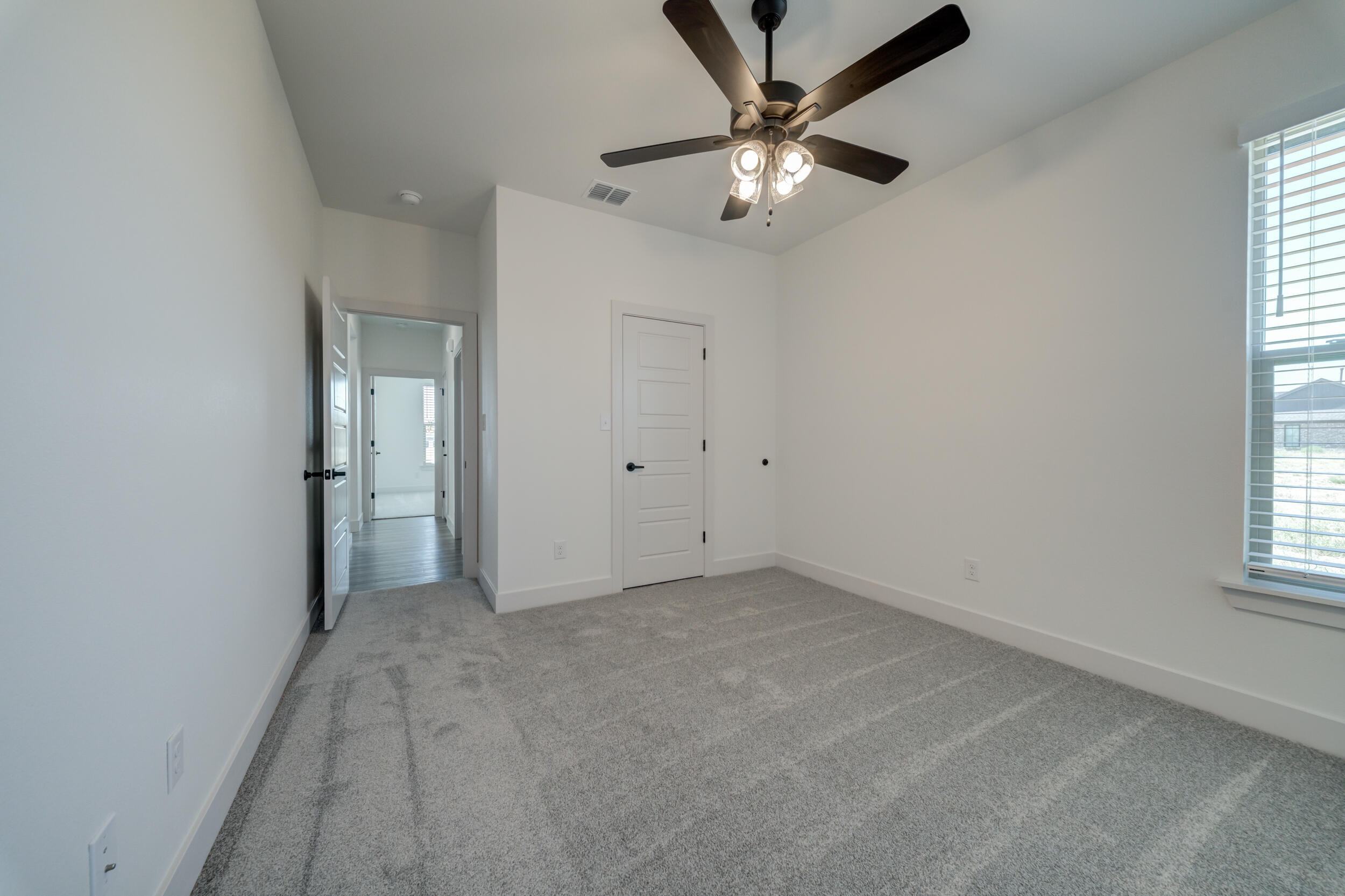 7522 56th Street Lubbock, TX 79407 - Photo 32 of 47 an empty room with chandelier fan and windows