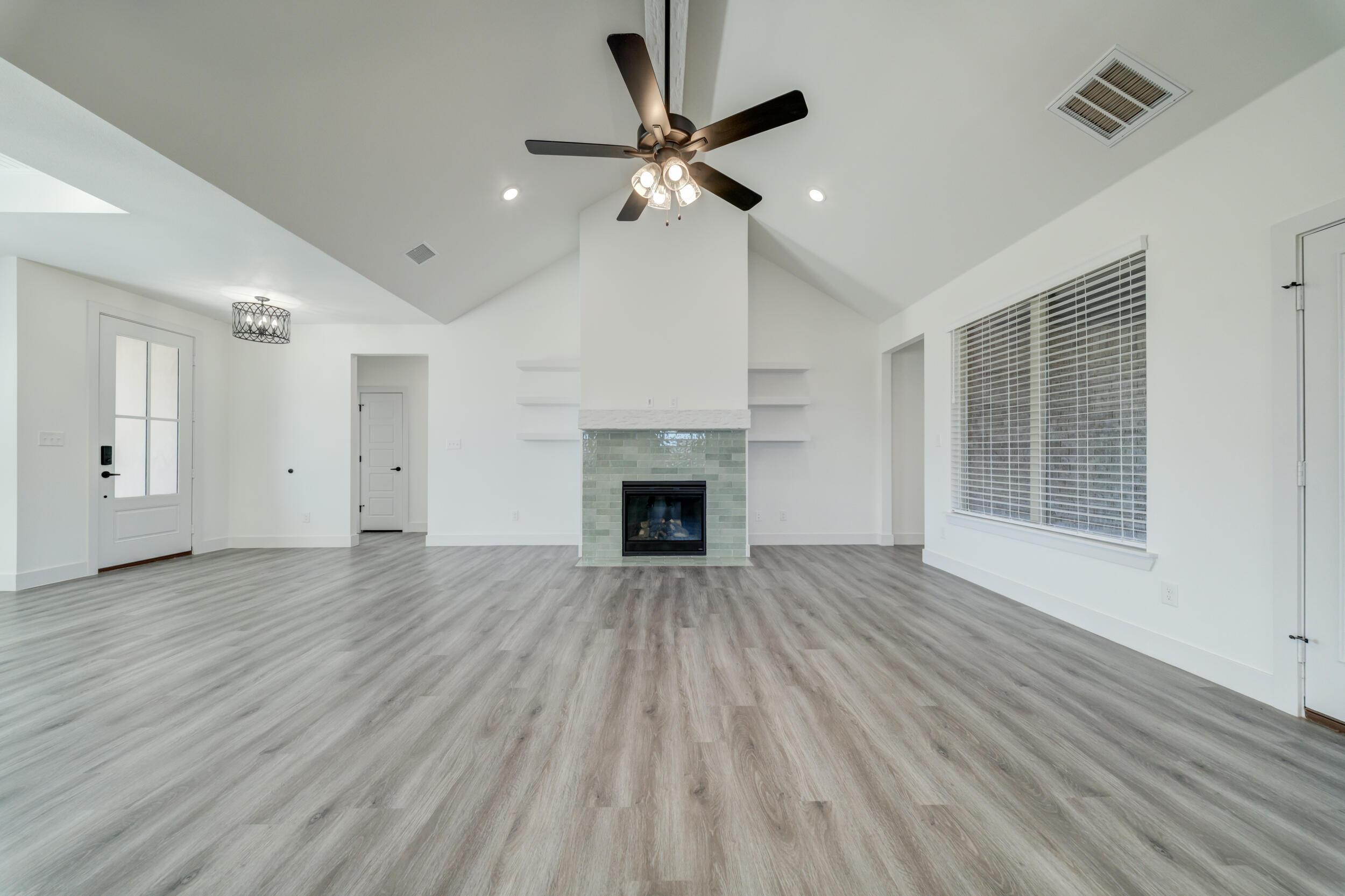 7522 56th Street Lubbock, TX 79407 - Photo 5 of 47 a view of an empty room with wooden floor fireplace and a window