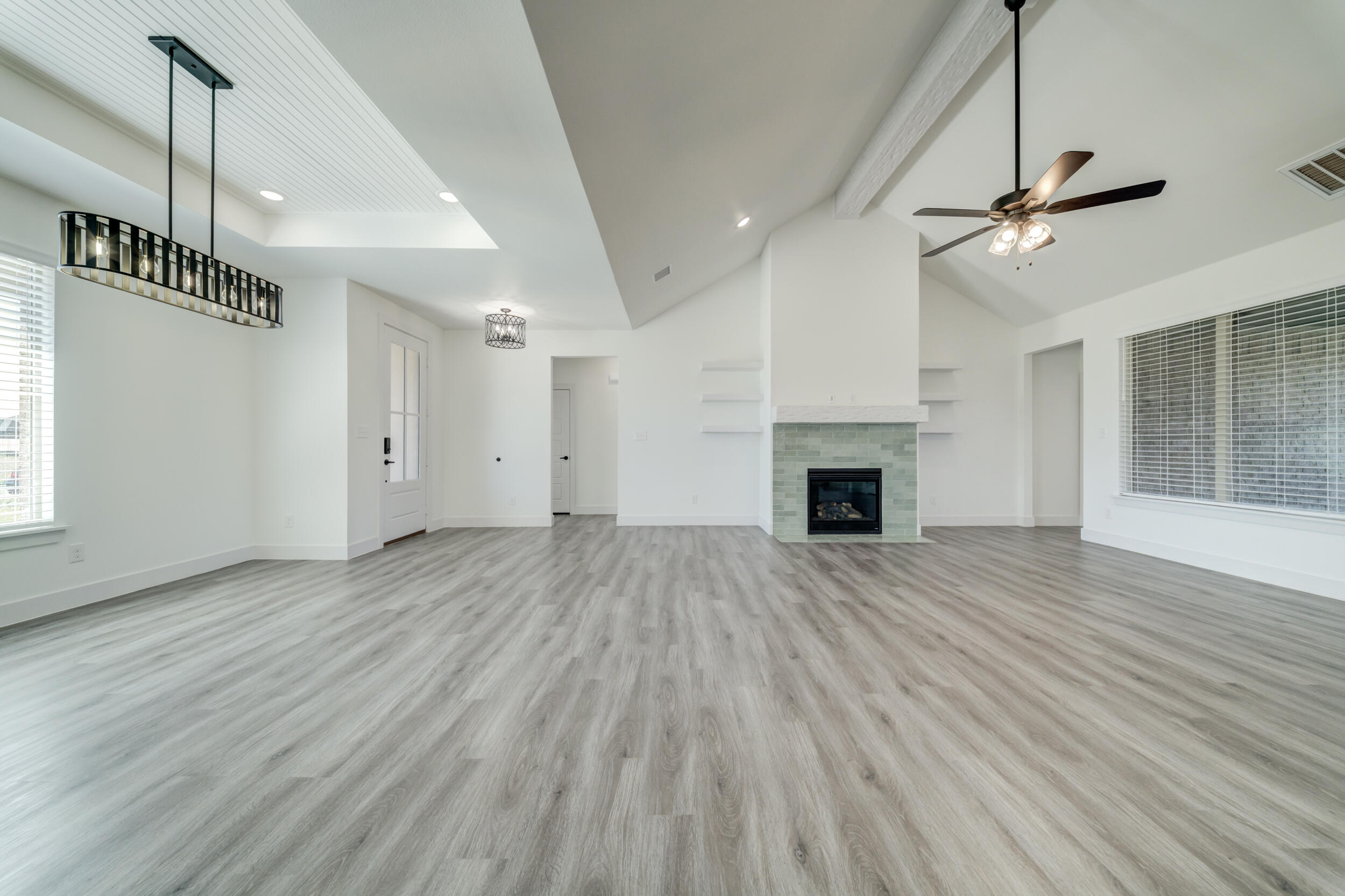 7522 56th Street Lubbock, TX 79407 - Photo 6 of 47 a view of empty room with wooden floor and fireplace