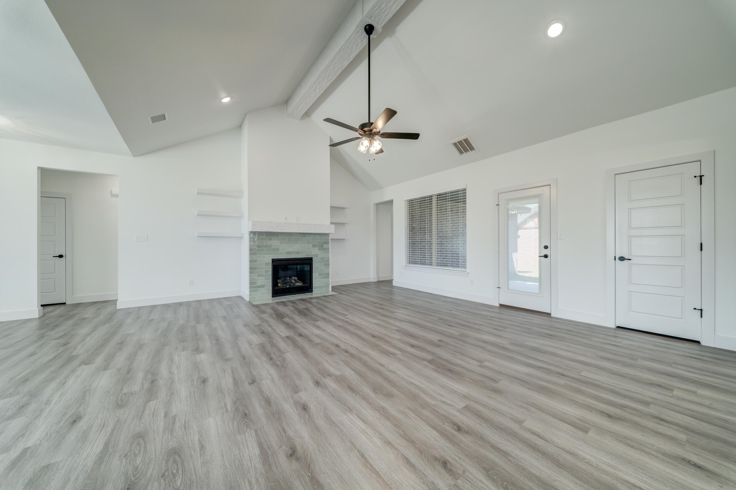 7522 56th Street Lubbock, TX 79407 - Photo 7 of 47 a view of empty room with wooden floor and fireplace