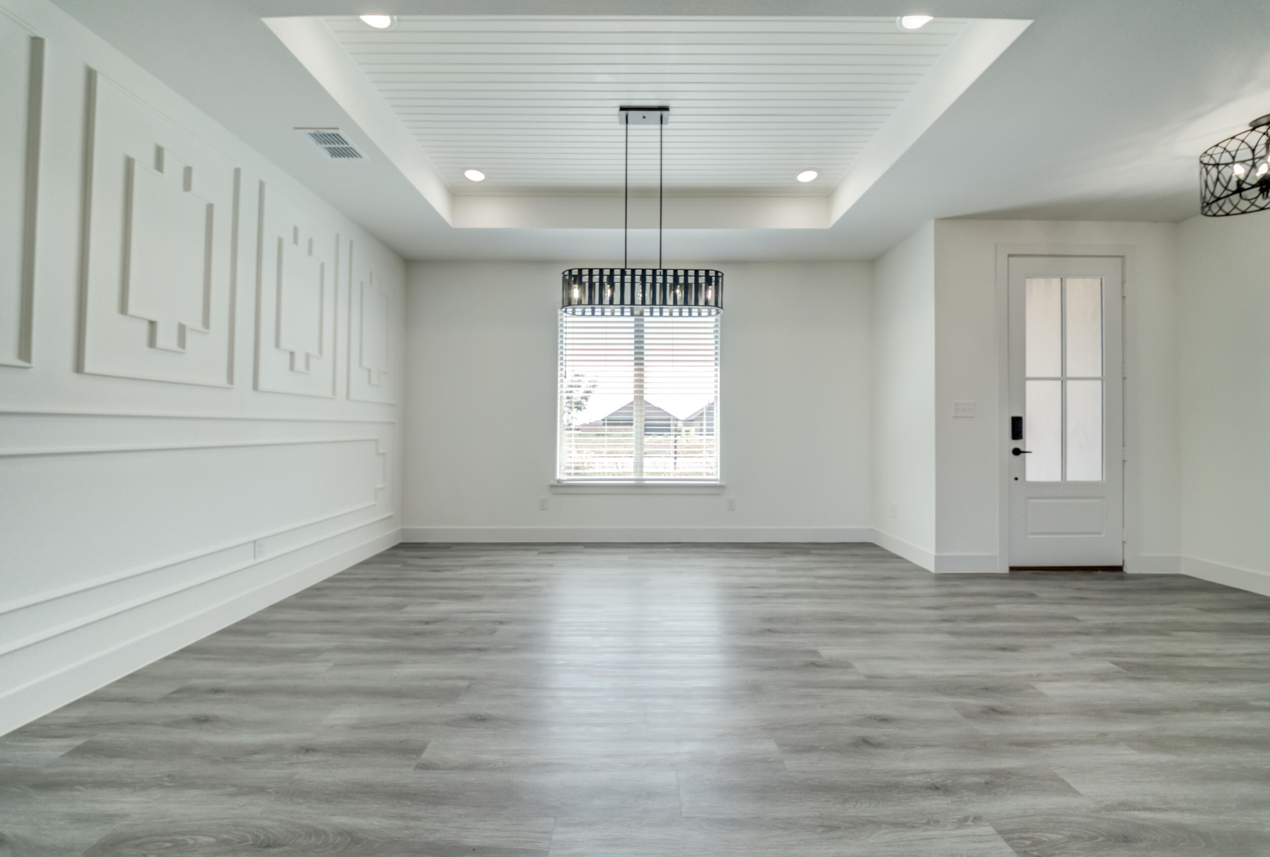 7522 56th Street Lubbock, TX 79407 - Photo 8 of 47 a view of empty room with wooden floor and fan