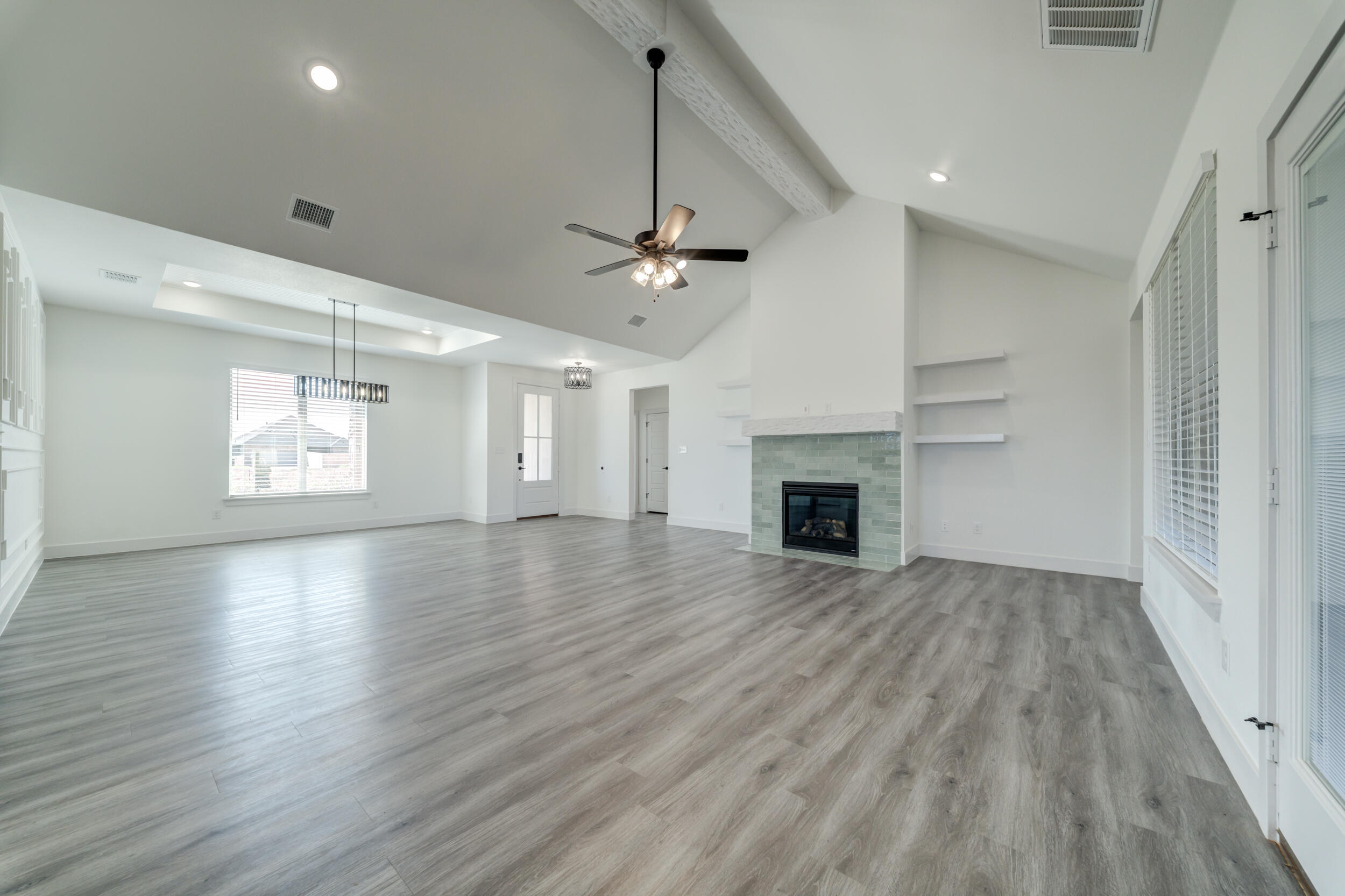 7522 56th Street Lubbock, TX 79407 - Photo 10 of 47 an empty room with windows and a fireplace