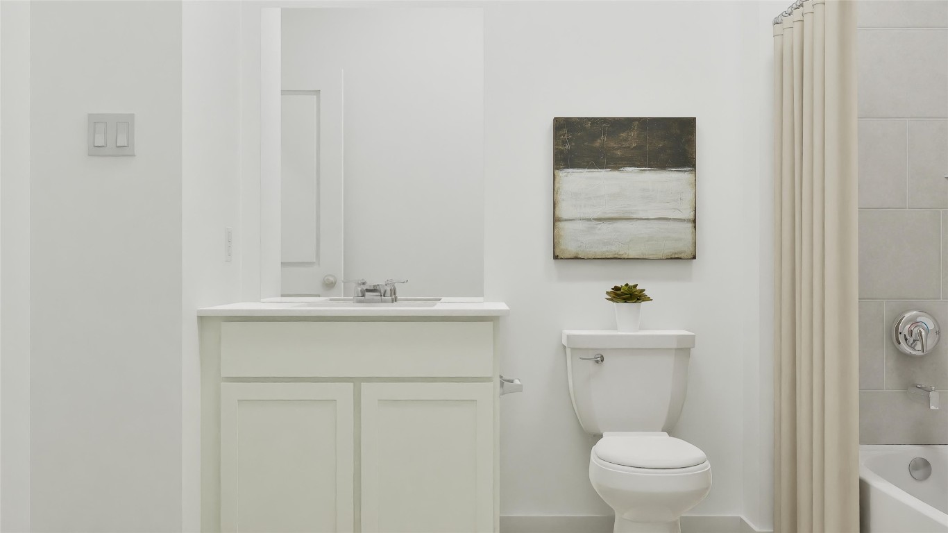 179 Rodney Boat Road Kyle, TX 78640 - Photo 22 of 26 a bathroom with a toilet a sink a mirror and a shower