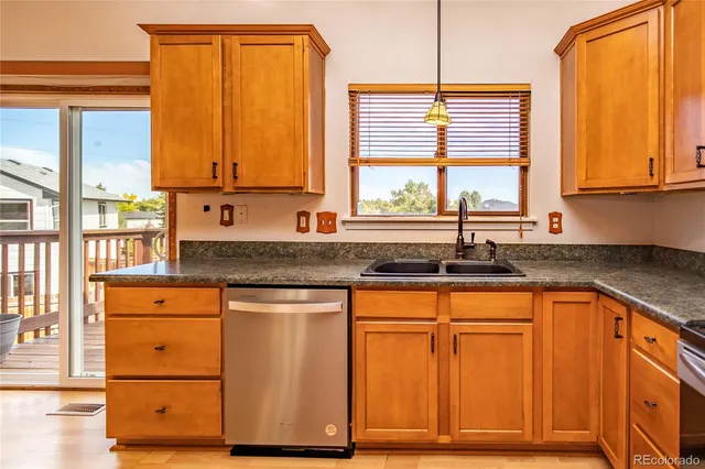 a kitchen with stainless steel appliances granite countertop a sink and a window