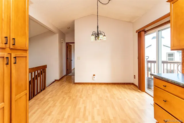 a view of a room with wooden floor and windows