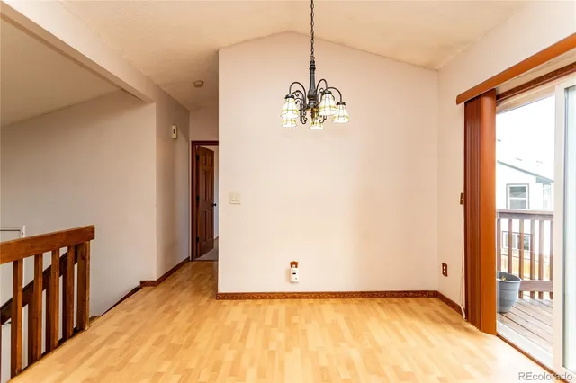 a view of a bedroom with wooden floor and a window