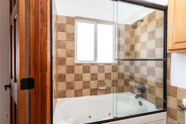 a bathroom with a bathtub and shower