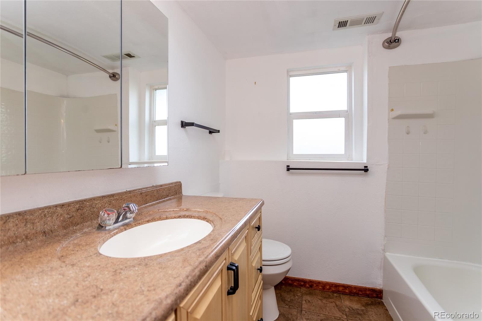650 Howe Circle Castle Rock, CO 80104 - Photo 23 of 45 a bathroom with a sink toilet a mirror and shower