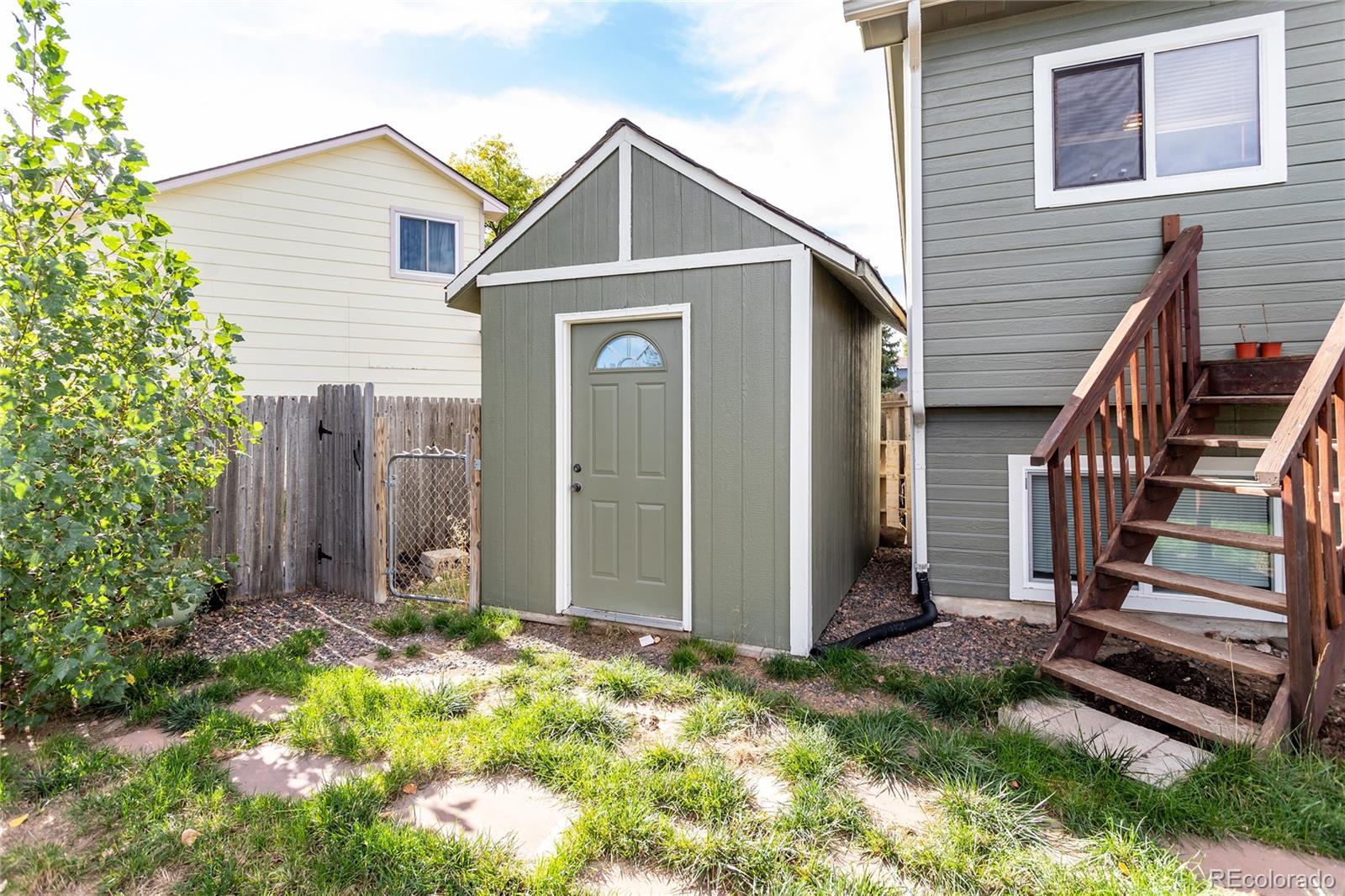 650 Howe Circle Castle Rock, CO 80104 - Photo 35 of 45 a view of a house with wooden fence and a large tree