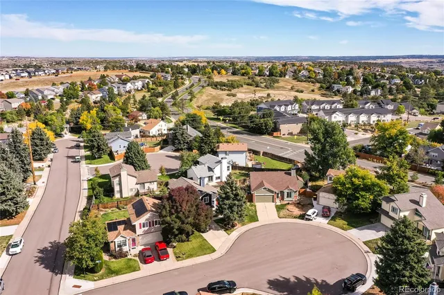 an aerial view of residential houses with outdoor space