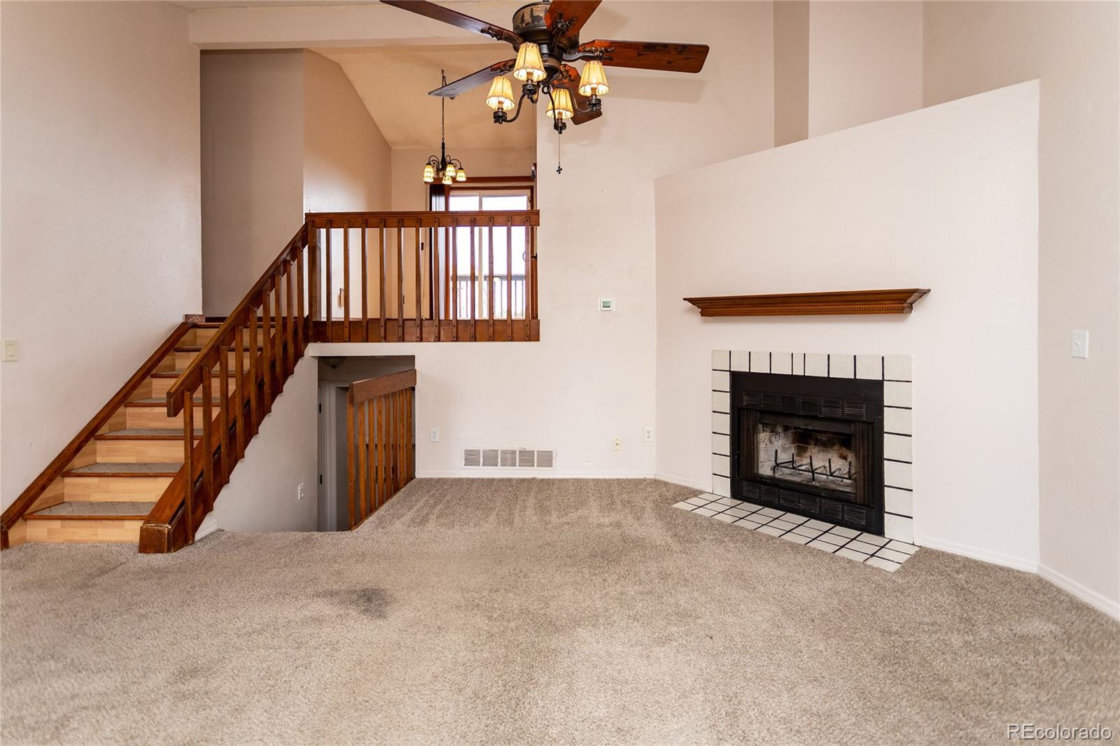650 Howe Circle Castle Rock, CO 80104 - Photo 6 of 45 a view of an empty room with stairs and a fireplace