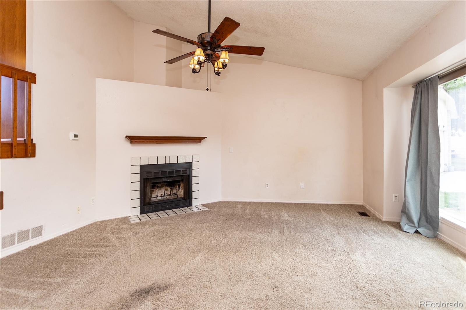 650 Howe Circle Castle Rock, CO 80104 - Photo 8 of 45 an empty room with windows and a fireplace