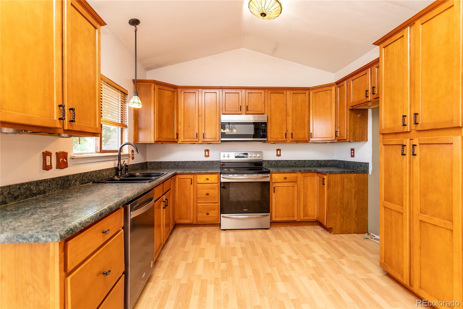 650 Howe Circle Castle Rock, CO 80104 - Photo 10 of 45 a kitchen with stainless steel appliances granite countertop a sink a stove and a refrigerator