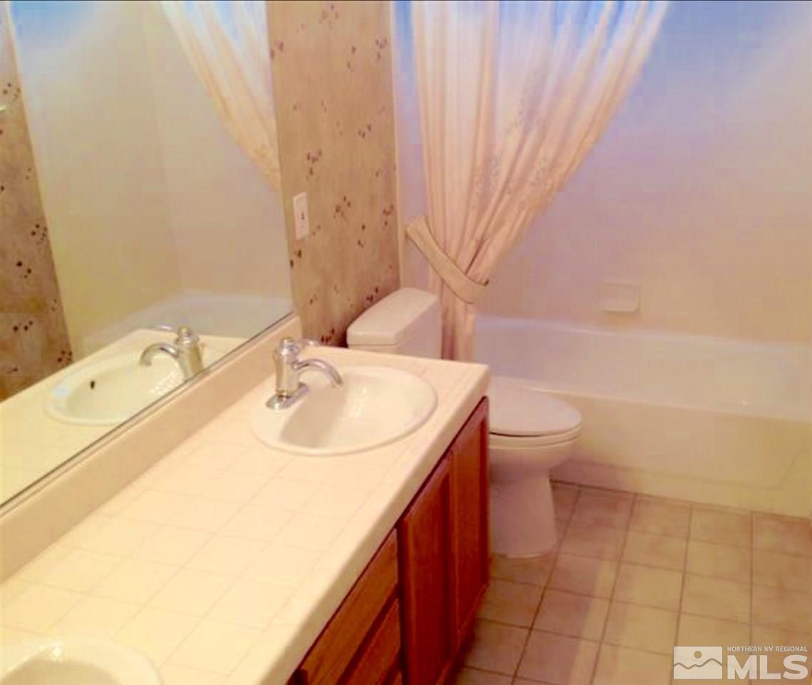 1413 Gaucho Lane Reno, NV 89521 - Photo 15 of 24 a bathroom with a sink a toilet and shower