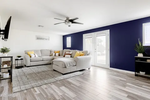 a living room with furniture and a wooden floor