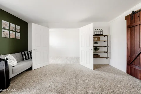 a view of a livingroom with furniture and staircase