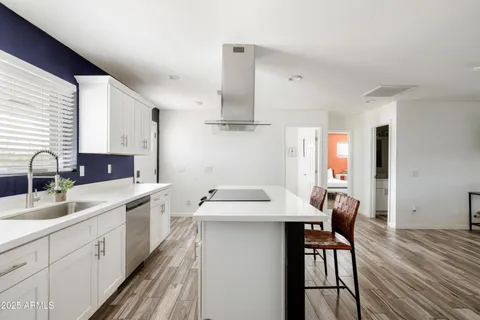 a kitchen with stainless steel appliances a sink stove and cabinets