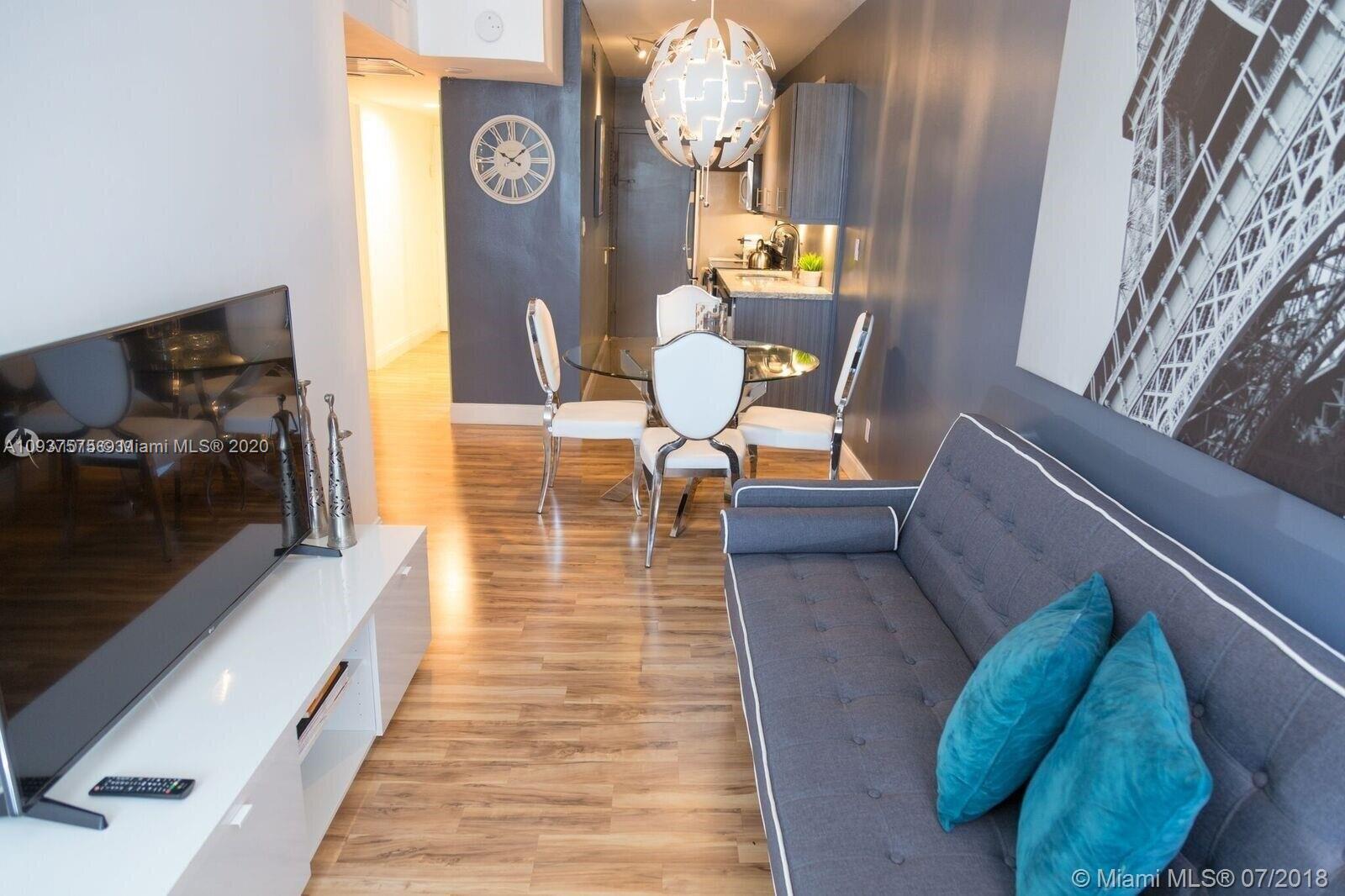 100 Lincoln Road, Unit 309 Miami Beach, FL 33139 - Photo 1 of 17 a view of a couches and a dining table in a balcony