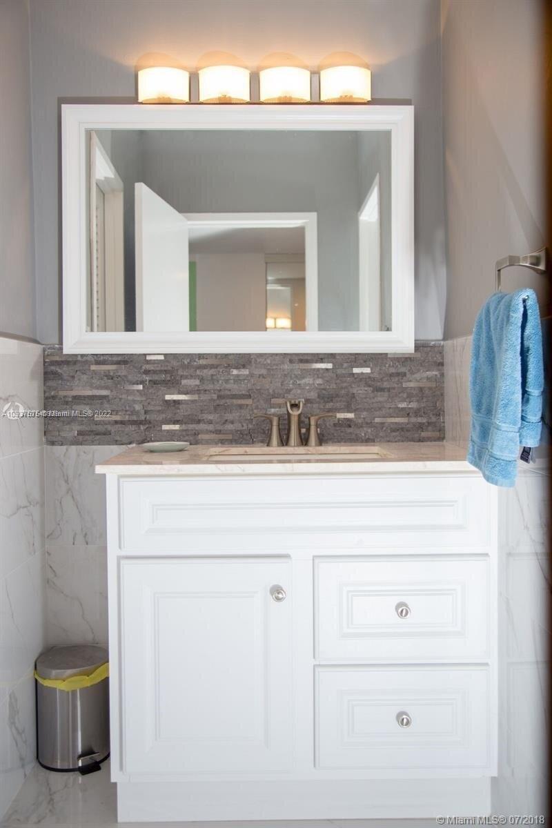 100 Lincoln Road, Unit 309 Miami Beach, FL 33139 - Photo 9 of 17 a bathroom with a sink and a mirror