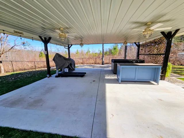 a open kitchen with stainless steel appliances granite countertop a refrigerator a sink dishwasher a stove and white countertops with wooden floor