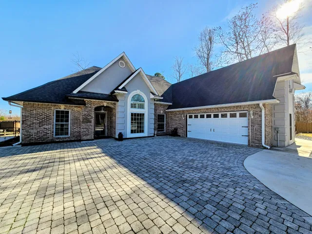 a view of a house with a yard and garage