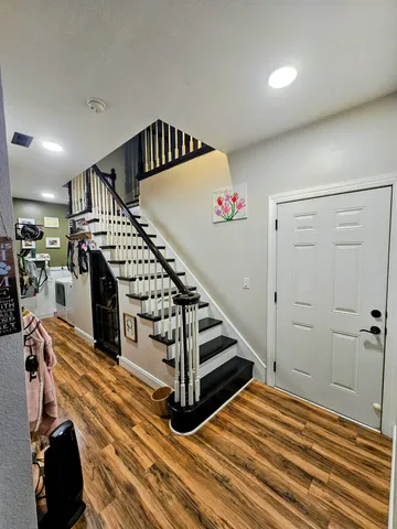 a bedroom with a bed a dresser and window