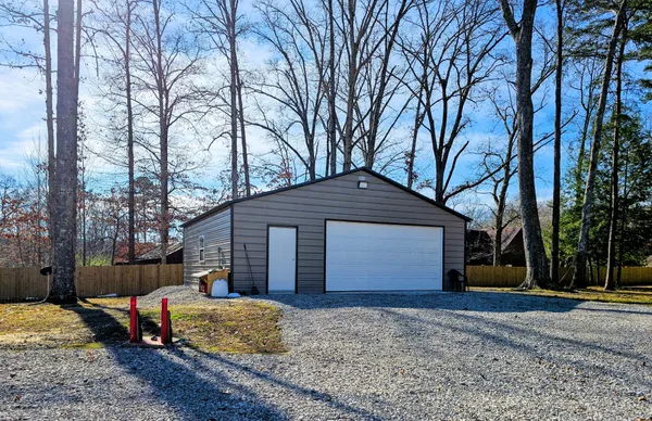 a view of a house with a yard covered with snow
