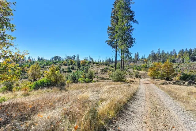 a view of a lake with sunset in background