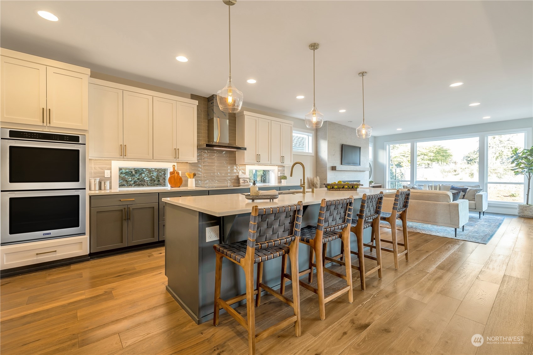 421 Rockefeller Avenue Everett, WA 98201 - Photo 8 of 35 a kitchen with stainless steel appliances granite countertop a stove a sink a microwave a island with a dining table and chairs