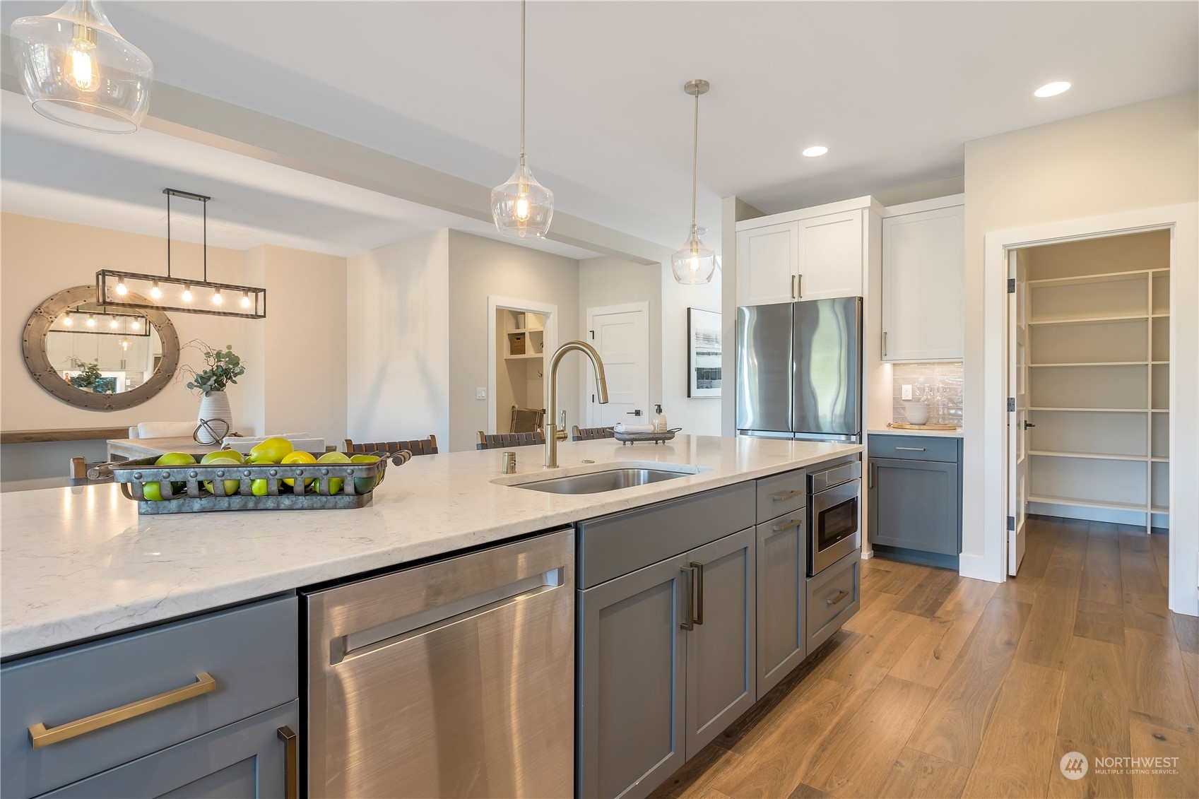 421 Rockefeller Avenue Everett, WA 98201 - Photo 10 of 35 a kitchen with a sink dishwasher a refrigerator a dining table and chairs with wooden floor