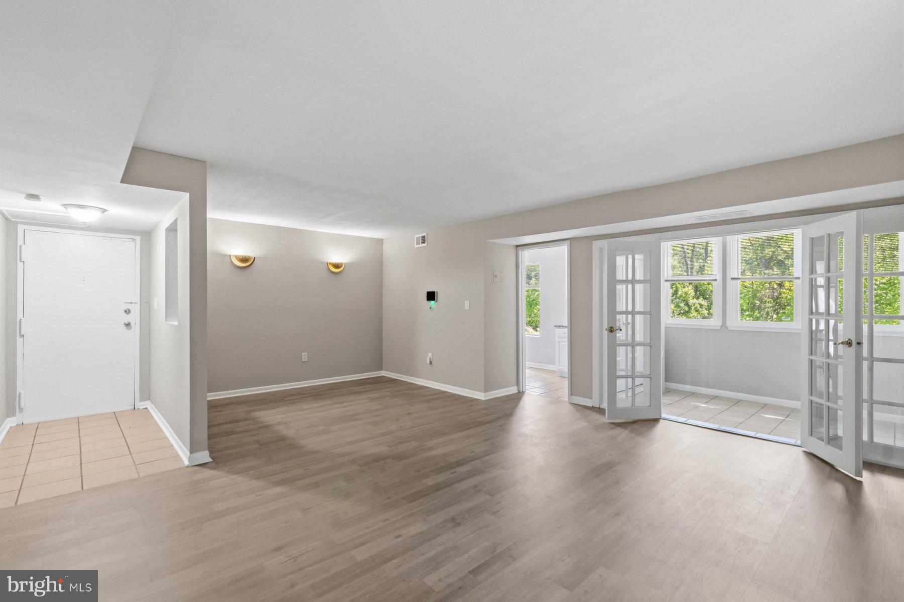 5866 Thunder Hill Road, Unit A4 Columbia, MD 21045 - Photo 7 of 21 Spacious living room and sunroom