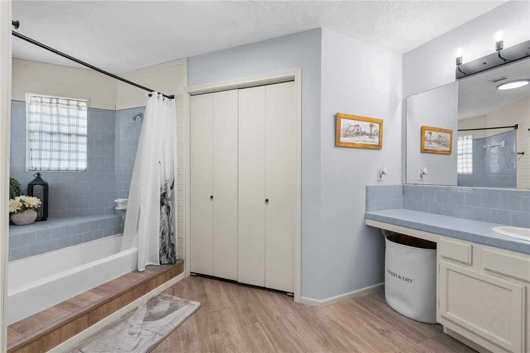 2098 Cedar Creek Road Hearne, TX 77859 - Photo 11 of 18 a view of a kitchen cabinets a bed and wooden floor